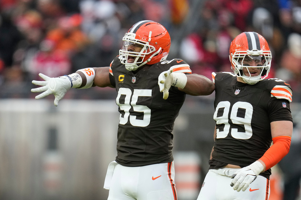 Cleveland Browns defensive end Myles Garrett (95) celebrates after sacking San Francisco 49ers quarterback Brock Purdy with defensive end Cameron Thomas (99) during the second half of an NFL football game, Sunday, Nov. 30, 2025, in Cleveland. (AP Photo/Sue Ogrocki)