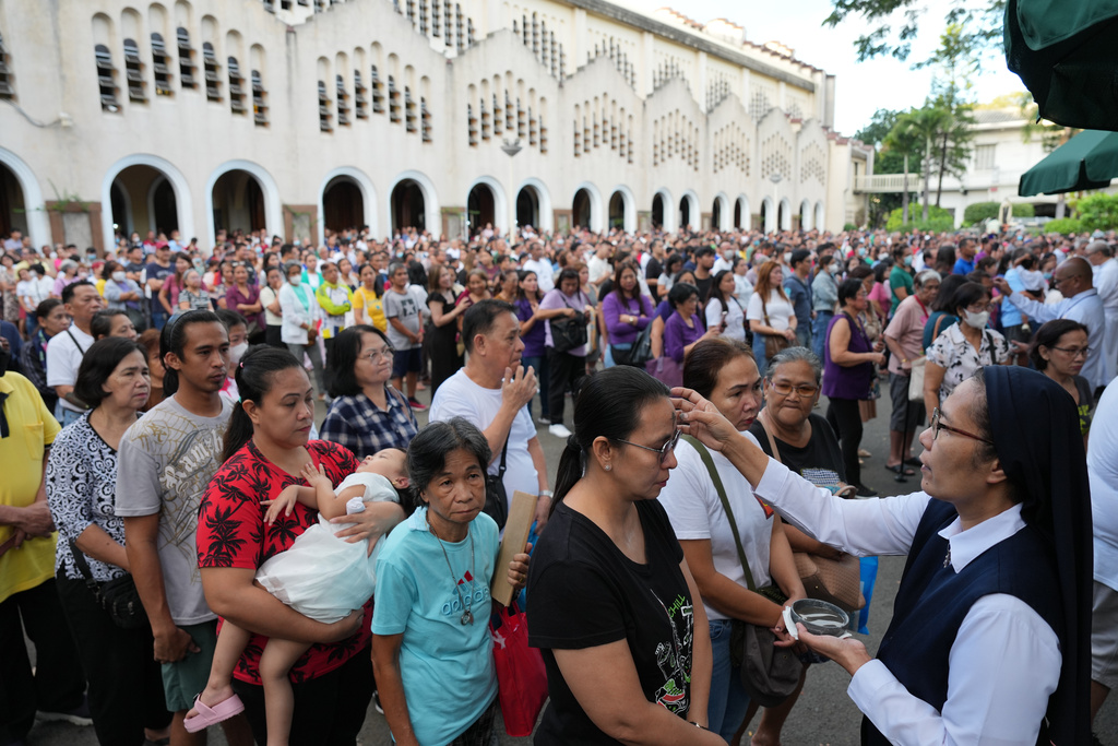 A Catholic nun places an ash cross on the forehead of a devotee during Ash Wednesday rites Wednesday, Feb. 18, 2026, at the Redemptorist Church in Manila, Philippines as Catholics observe the start of lent. (AP Photo/Aaron Favila)
