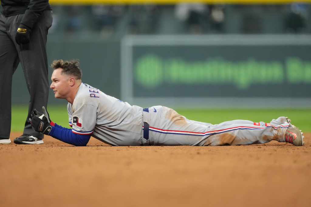 Texas Rangers' Joc Pederson reacts after being put out at second base while trying to stretch a single into a double in the third inning of a baseball game against the Colorado Rockies, Tuesday, May 19, 2026, in Denver. (AP Photo/David Zalubowski)
