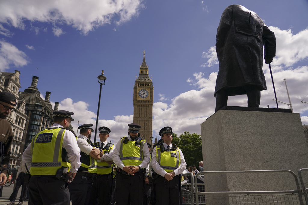 Police officers line up before a demonstration in support of the Palestinian People in Gaza, in Parliament Square, in London, Saturday, Aug. 9, 2025.(AP Photo/Alberto Pezzali)