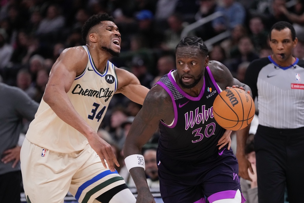 Minnesota Timberwolves' Julius Randle gets past Milwaukee Bucks' Giannis Antetokounmpo during the first half of an NBA basketball game Tuesday, Jan. 13, 2026, in Milwaukee. (AP Photo/Morry Gash)