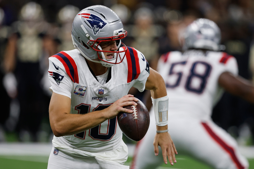 New England Patriots quarterback Drake Maye runs with the ball during the second half of an NFL football game against the New Orleans Saints, Sunday, Oct. 12, 2025, in New Orleans. (AP Photo/Butch Dill)