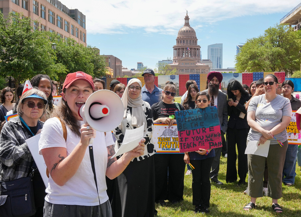 Emily Glankler, an Austin social studies teacher, speaks during a rally on the Capitol Mall outside the Barbara Jordan State Office Building, where the State Board of Education meets, Tuesday, April 7, 2026, in Austin, Texas. (Jay Janner/Austin American-Statesman via AP)
