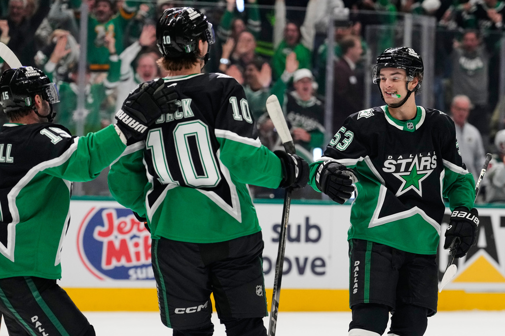 Dallas Stars' Colin Blackwell (15), Oskar Bäck (10) and Wyatt Johnston (53) celebratee Johnston's goal in the first period of Game 2 of a first-round NHL Stanley Cup playoffs hockey series against the Minnesota Wild Monday, April 20, 2026, in Dallas. (AP Photo/Tony Gutierrez)un
