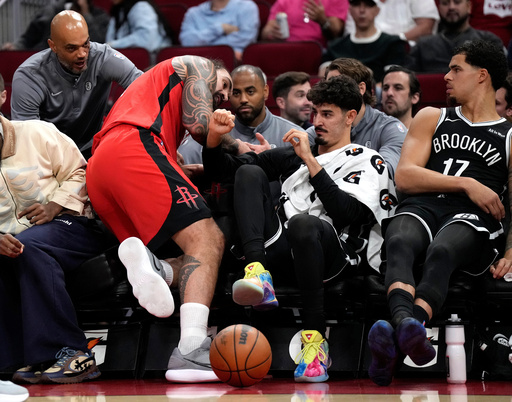 Houston Rockets center Steven Adams, left, falls into the Brooklyn Nets bench, nearly colliding with Ben Saraf, right, during the first half of an NBA basketball game Monday, Oct. 27, 2025, in Houston. (AP Photo/Karen Warren) Houston Rockets center Steven Adams, left, falls into the Brooklyn Nets bench, nearly colliding with Ben Saraf, right, during the first half of an NBA basketball game Monday, Oct. 27, 2025, in Houston. (AP Photo/Karen Warren)