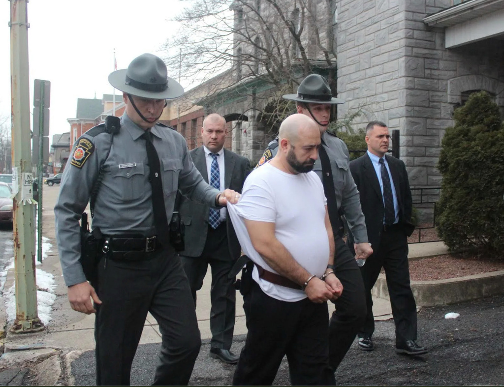 John Edward Kurtz, a former prison guard, is taken by state troopers to be arraigned in Milton, Pa., Dec. 18, 2017. (Kevin Mertz/Standard Journal via AP)