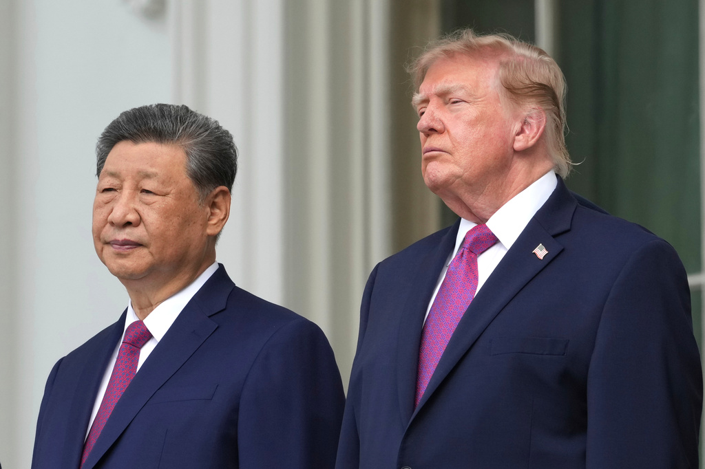 President Donald Trump, right, China's President Xi Jinping watch a silent drill platoon review on the new helipad from the Blue Room Balcony of the White House, Thursday, Sept. 24, 2026, in Washington. (AP Photo/Alex Brandon)