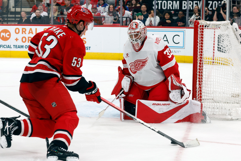 Carolina Hurricanes' Jackson Blake (53) controls the puck saw he approaches Detroit Red Wings goaltender Cam Talbot (39) during the second period of an NHL hockey game in Raleigh, N.C., Saturday, Feb. 28, 2026. (AP Photo/Karl DeBlaker)
