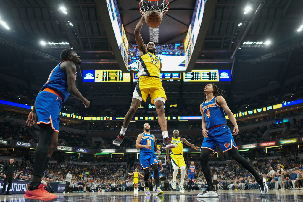 Indiana Pacers forward Isaiah Jackson (22) dunks in front of New York Knicks forward Pacome Dadiet (4) during the first half of an NBA basketball game in Indianapolis, Thursday, Dec. 18, 2025. (AP Photo/AJ Mast)