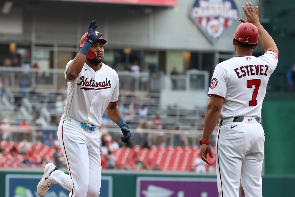 Washington Nationals' James Wood, left, is greeted by third base coach Victor Estevez (7) after hitting a home run off Houston Astros pitcher Tatsuya Imai during the first inning of a baseball game, Tuesday, July 7, 2026, in Washington. (AP Photo/Terrance Williams)