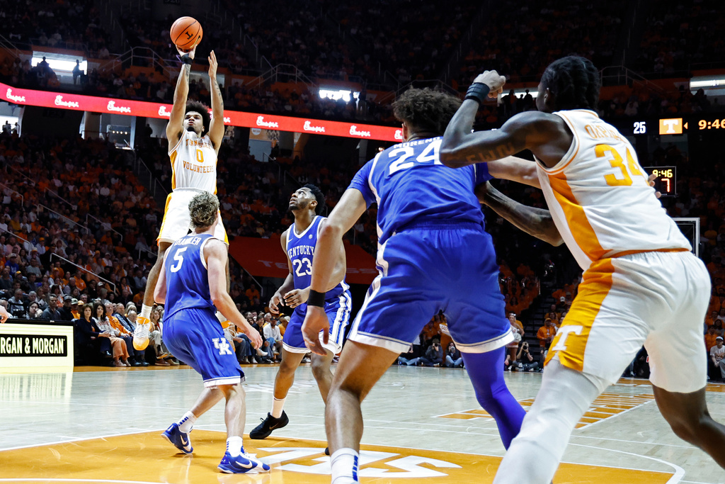 Tennessee guard Ja'kobi Gillespie (0) shoots over Kentucky guard Collin Chandler (5) during the first half of an NCAA college basketball game Saturday, Jan. 17, 2026, in Knoxville, Tenn. (AP Photo/Wade Payne)