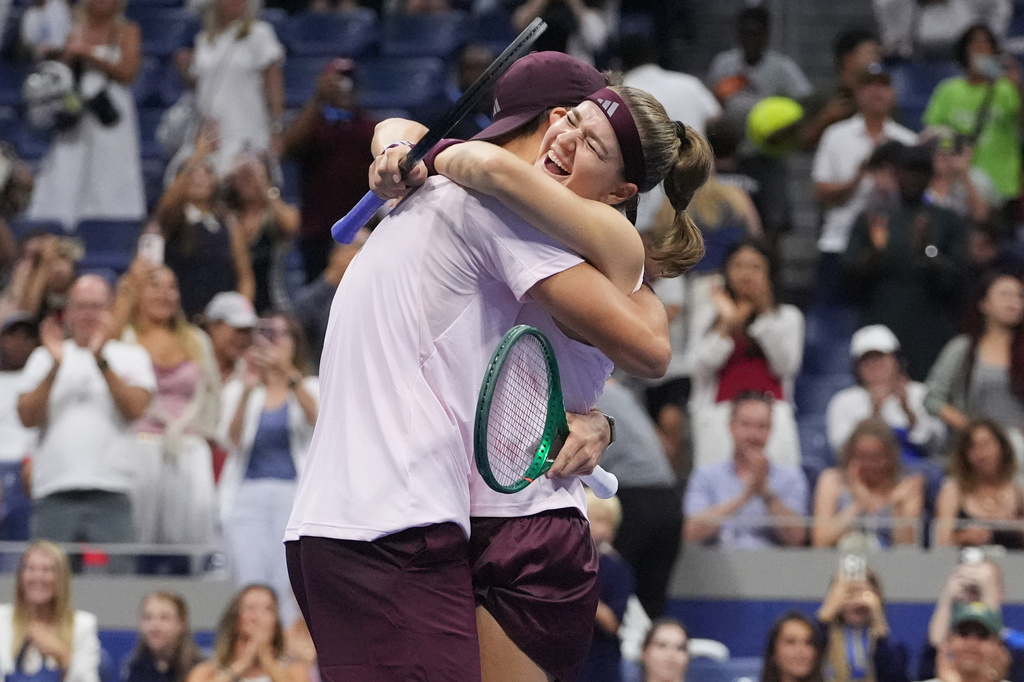 Jakub Mensik, of the Czech Republic, celebrates with Karolina Muchova, right, of the Czech Republic, after they won the mixed doubles final match against Belinda Bencic, of Switzerland, and Flavio Cobolli, of Italy, at the U.S. Open tennis championships Wednesday, Aug. 26, 2026, in New York. (AP Photo/Frank Franklin II)