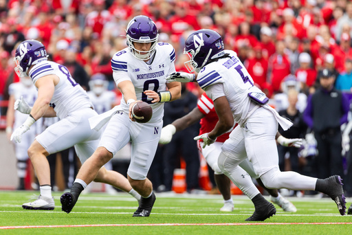 Northwestern quarterback Preston Stone (8) hands off the ball to running back Caleb Komolafe (5) during the first half of an NCAA college football game against Nebraska, Saturday, Oct. 25, 2025, in Lincoln, Neb. (AP Photo/Bonnie Ryan) Northwestern quarterback Preston Stone (8) hands off the ball to running back Caleb Komolafe (5) during the first half of an NCAA college football game against Nebraska, Saturday, Oct. 25, 2025, in Lincoln, Neb. (AP Photo/Bonnie Ryan)