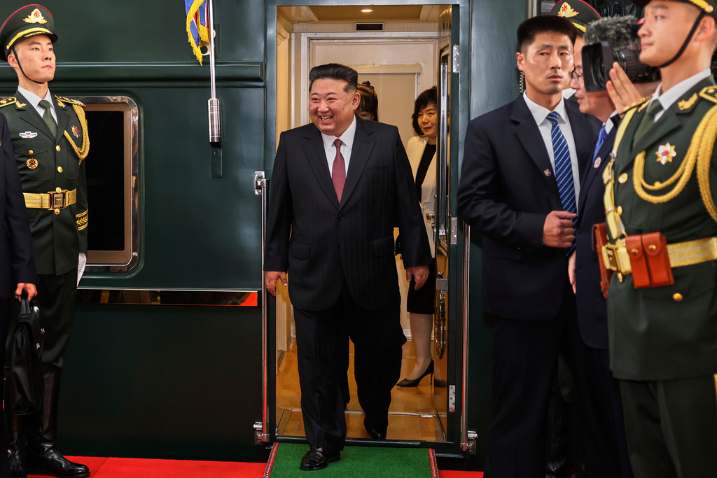 In this photo released by Xinhua News Agency, North Korea leader Kim Jong Un, center, disembarks from a train as he arrives at a railway station, in Beijing, China, Tuesday, Sept. 2, 2025. (Pang Xinglei/Xinhua via AP)