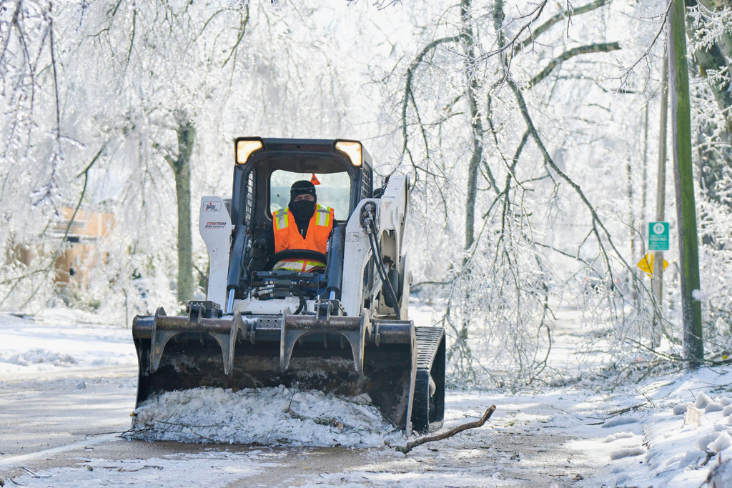 A worker clears a street of debris and ice in Oxford, Miss. on Monday, Jan. 26, 2026, following a weekend ice storm. (AP Photo/Bruce Newman)