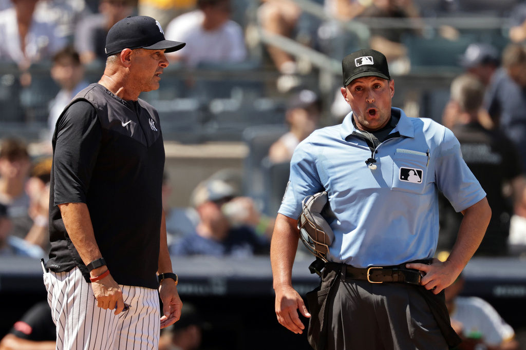New York Yankees manager Aaron Boone continues to argue with home plate umpire Quinn Wolcott (81) in the seventh inning after he charged Yankees batter José Caballero (72) with a pitch count violation in the sixth inning in the first baseball game of a doubleheader against the Pittsburgh Pirates, Wednesday, July 22, 2026, in New York. (AP Photo/Adam Hunger)