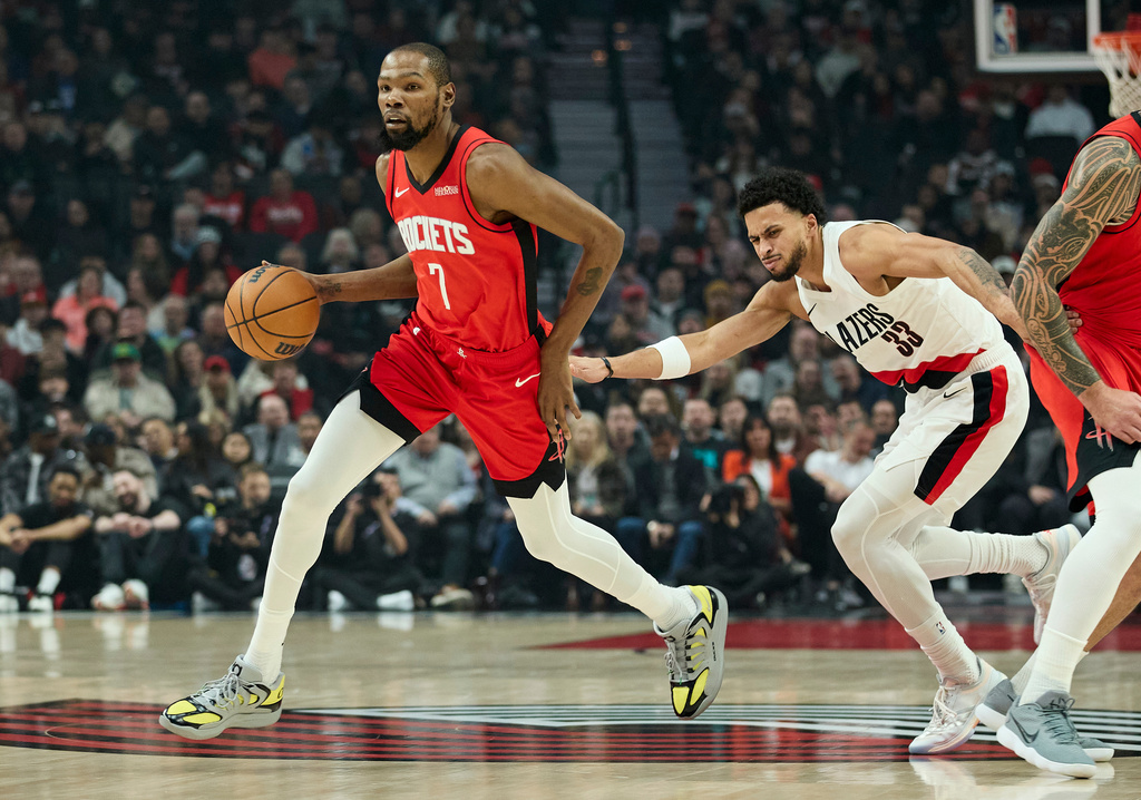 Houston Rockets forward Kevin Durant, left, dribbles around Portland Trail Blazers forward Toumani Camara during the first half of an NBA basketball game in Portland, Ore., Wednesday, Jan. 7, 2026. (AP Photo/Craig Mitchelldyer)