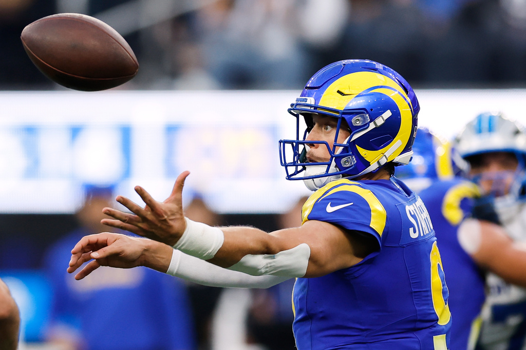 Los Angeles Rams quarterback Matthew Stafford (9) bobbles the snap during the second half of an NFL football game against the Detroit Lions, Sunday, Dec. 14, 2025, in Inglewood, Calif. (AP Photo/Caroline Brehman)