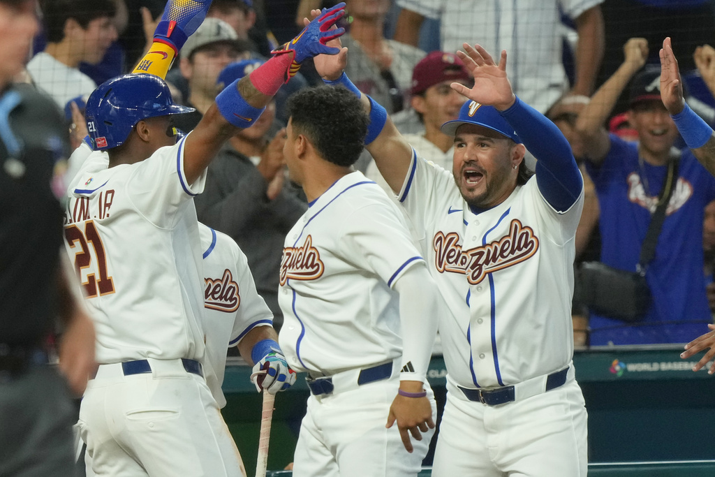 Venezuela's Ronald Acuña Jr. (21) celebrates after scoring during the first inning of a World Baseball Classic game against the Netherlands, Friday, March 6, 2026, in Miami. (AP Photo/Marta Lavandier)