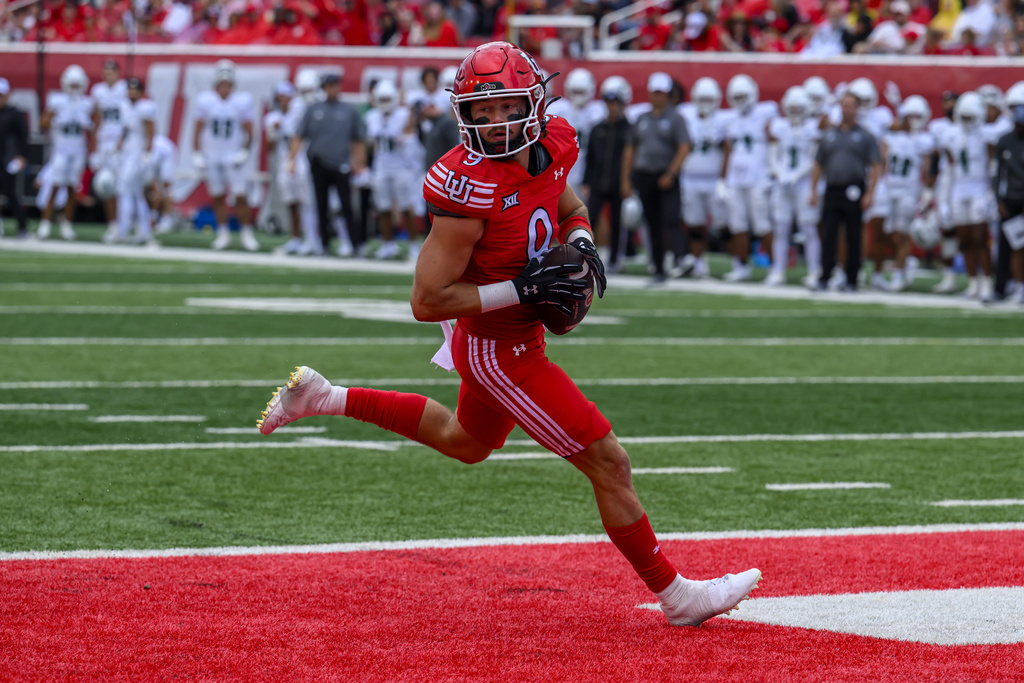 Utah wide receiver Ryan Davis (9) runs the ball in for a touchdown during an NCAA college football game against Cal Poly, Saturday, Sept. 6, 2025, in Salt Lake City, Utah. (AP Photo/Tyler Tate)