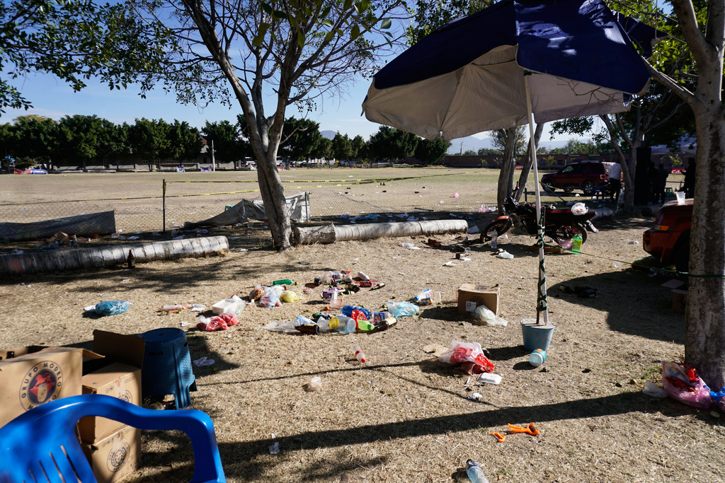 People's items left behind cover the ground at a soccer field the day after gunmen opened fire, killing and wounding people, in Salamanca, Mexico, Monday, Jan. 26, 2026. (AP Photo/Mario Armas)