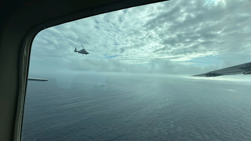 FILE - A Chinese military helicopter flies close to a Philippine Bureau of Fisheries and Aquatic (BFAR) aircraft above Scarborough shoal on Feb. 18, 2025. (AP Photo/Joeal Calupitan, File) FILE - A Chinese military helicopter flies close to a Philippine Bureau of Fisheries and Aquatic (BFAR) aircraft above Scarborough shoal on Feb. 18, 2025. (AP Photo/Joeal Calupitan, File)