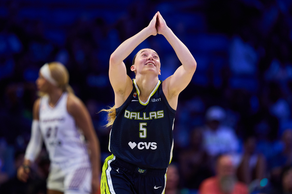 Dallas Wings' Paige Bueckers celebrates after sinking a basket in the second half of a WNBA basketball game against the Toronto Tempo in Arlington, Texas, Wednesday, Aug. 12, 2026. (AP Photo/Tony Gutierrez)
