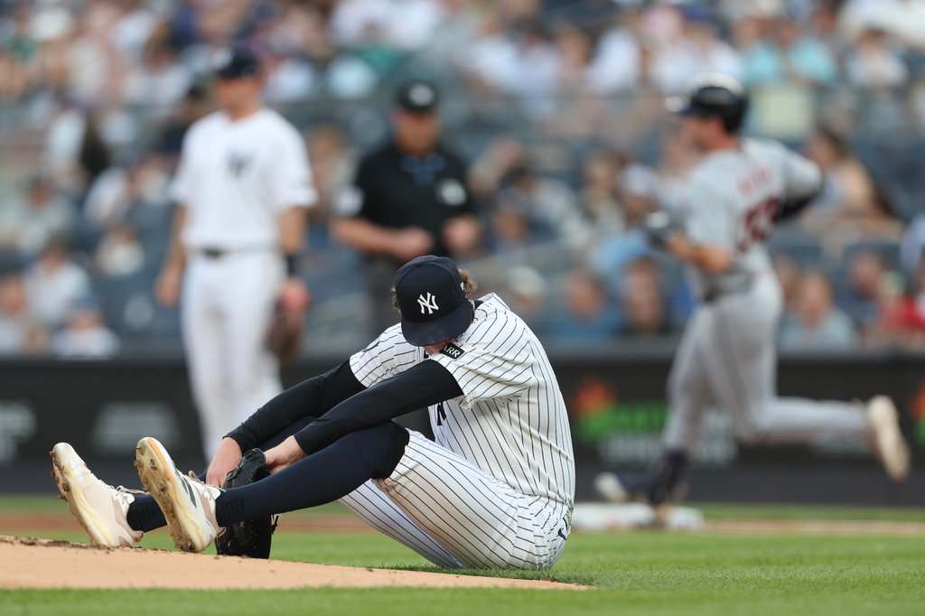 New York Yankees pitcher Cam Schlittler sits on the mound as Detroit Tigers' Colt Keith runs to first base during the first inning of a baseball game, Tuesday, June 30, 2026, in New York. (AP Photo/Heather Khalifa)