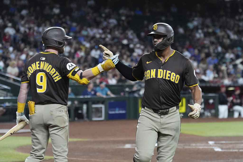 San Diego Padres' Xander Bogaerts, right, celebrates his home run against the Arizona Diamondbacks with Padres' Jake Cronenworth (9) during the second inning of a baseball game Tuesday, Aug. 5, 2025, in Phoenix. (AP Photo/Ross D. Franklin)