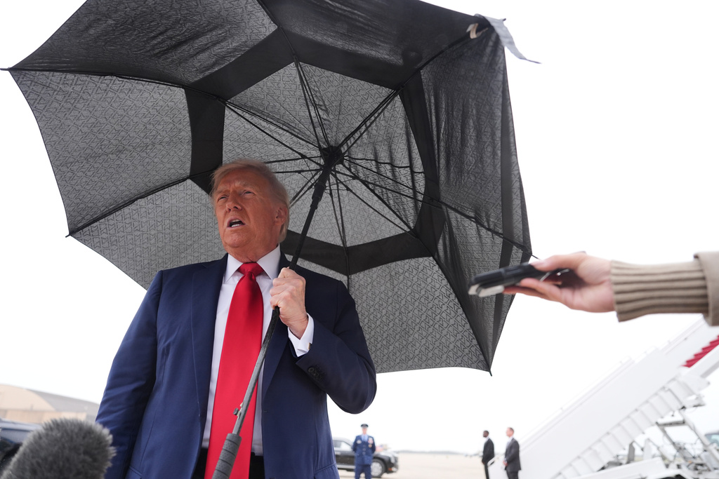 President Donald Trump speaks with reporters before boarding Air Force One, Sunday, Oct. 12, 2025, at Joint Base Andrews, Md., as he heads to the Middle East. (AP Photo/Evan Vucci)