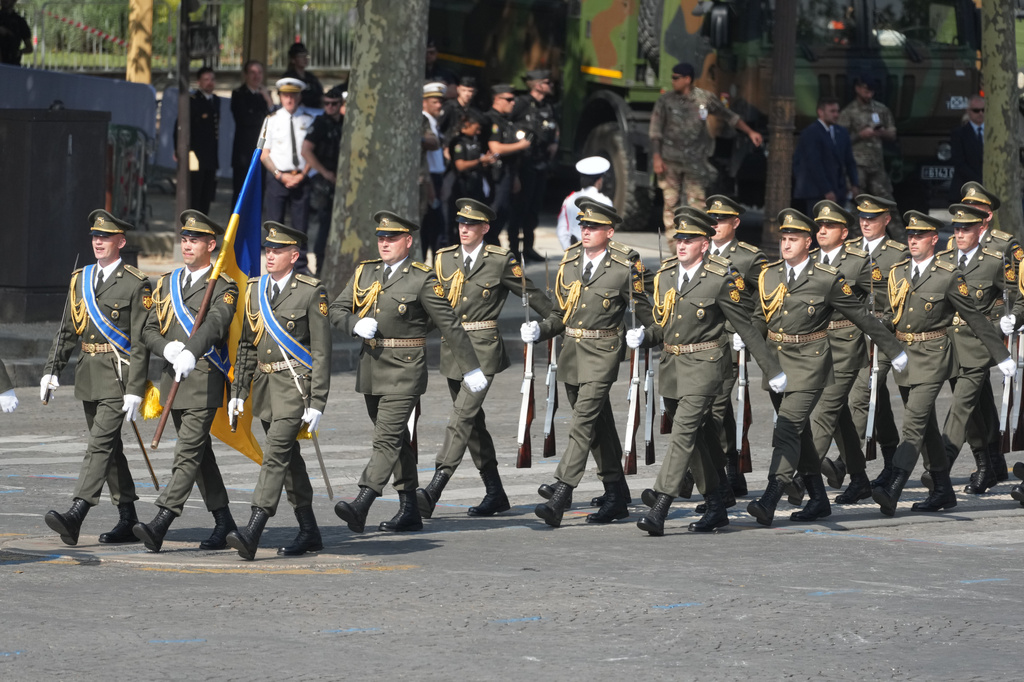 Ukrainian soldiers march during the Bastille Day military parade on the Champs-Elysees avenue, in Paris, Tuesday, July 14, 2026. (AP Photo/Michel Euler)