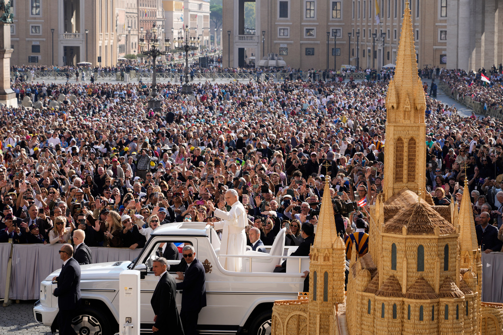 Pope Leo XIV waves as he arrives for his weekly general audience in St. Peter's Square at The Vatican, Wednesday, Oct.1, 2025. (AP Photo/Gregorio Borgia)
