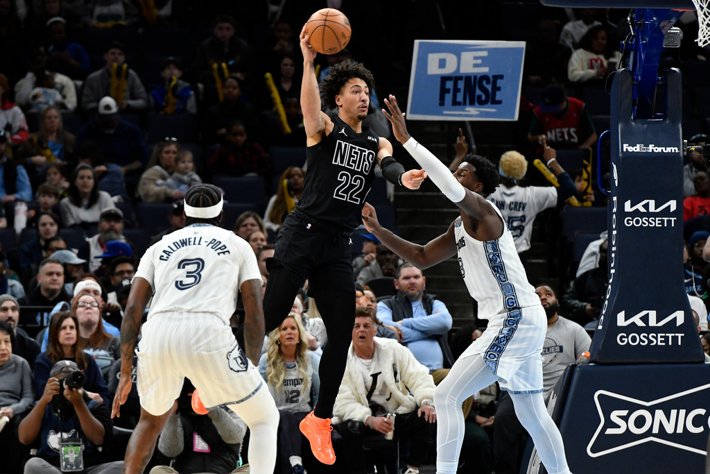 Brooklyn Nets forward Jalen Wilson (22) passes over Memphis Grizzlies forward Jaren Jackson Jr. and guard Kentavious Caldwell-Pope (3) in the first half of an NBA basketball game, Sunday, Jan. 11, 2026, in Memphis, Tenn. (AP Photo/Brandon Dill)