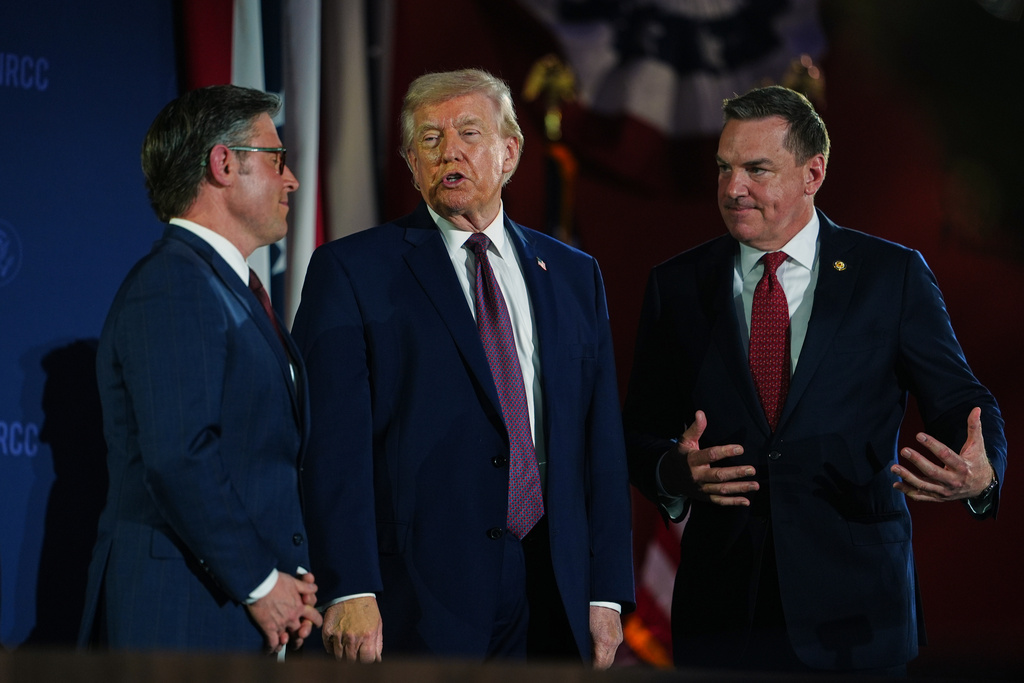 President Donald Trump talks with House Speaker Mike Johnson of La., and Rep. Richard Hudson, R-N.C., chair of the Naational Republican Congressional Committee (NRCC), at the annual fundraising dinner, Wednesday, March 25, 2026, at Union Station in Washington. (AP Photo/Julia Demaree Nikhinson)