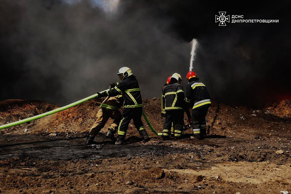 In this photo provided by the Ukrainian Emergency Service, emergency services personnel work to extinguish a fire following a Russian drone attack on a gas pipeline in Dnipropetrovsk region, Ukraine, Wednesday, May 13, 2026. (Ukrainian Emergency Service via AP)