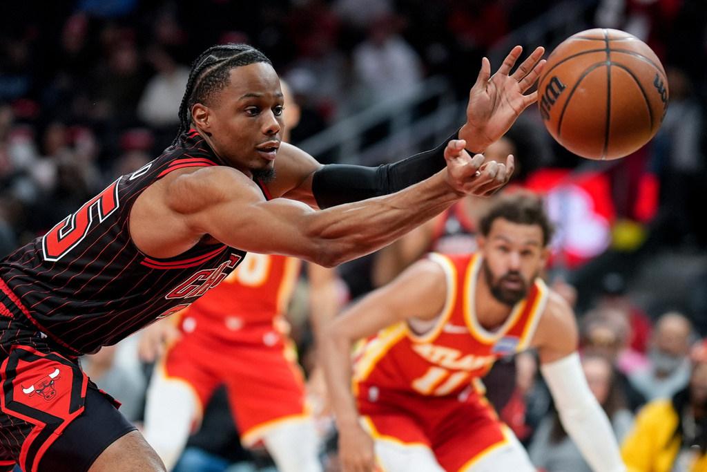 Chicago Bulls forward Isaac Okoro (35) vies for a loose ball against the Atlanta Hawks during the first half of an NBA basketball game, Tuesday, Dec. 23, 2025, in Atlanta. (AP Photo/Mike Stewart)