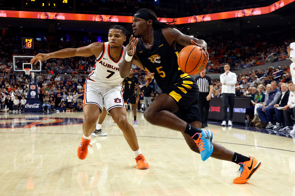 Bethune-Cookman forward Quentin Heady (5) drives the baseline around Auburn guard Keyshawn Hall (7) during the first half of an NCAA college basketball game, Monday, Nov. 3, 2025, in Auburn, Ala. (AP Photo/Butch Dill)