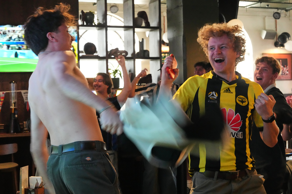 New Zealand supporters react as they watch the World Cup soccer match between New Zealand and Iran, in a bar in Wellington, New Zealand, Tuesday, June 16, 2026. (AP Photo/Charlotte Graham-McLay)