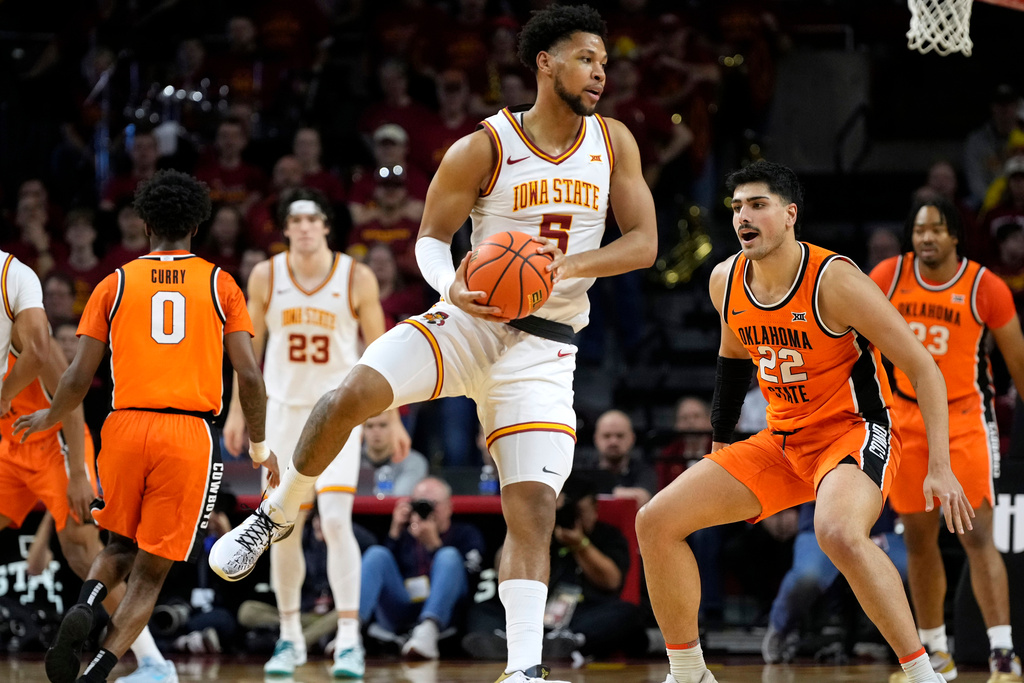 Iowa State forward Joshua Jefferson (5) runs down a loose ball ahead of Oklahoma State center Parsa Fallah (22) during the first half of an NCAA college basketball game, Saturday, Jan. 10, 2026, in Ames, Iowa. (AP Photo/Charlie Neibergall)