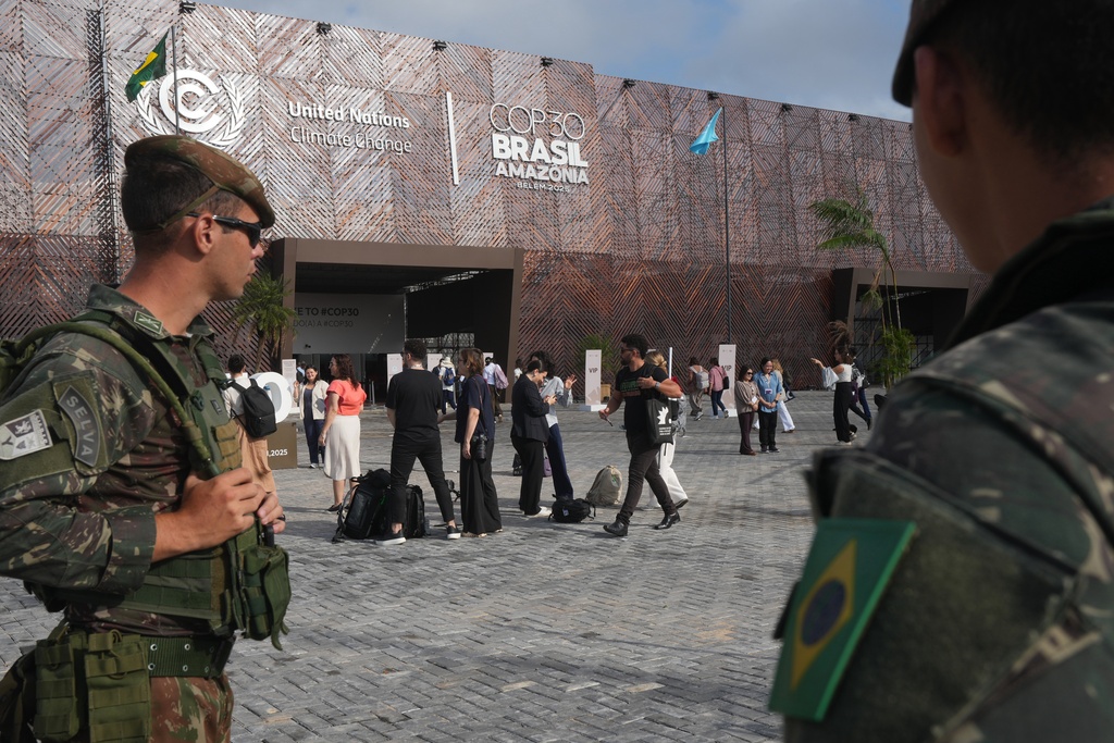 Security personnel monitor as attendees arrive to the COP30 U.N. Climate Summit, Tuesday, Nov. 18, 2025, in Belem, Brazil. (AP Photo/Andre Penner)
