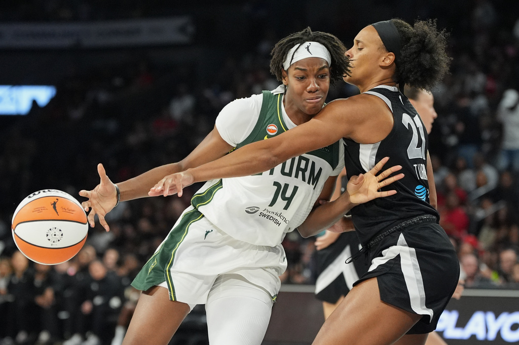 Seattle Storm center Dominique Malonga (14) drives against Las Vegas Aces forward Brianna Turner (21) during the second half of a WNBA basketball game Sunday, Sept. 20, 2026, in Las Vegas. (AP Photo/John Locher)