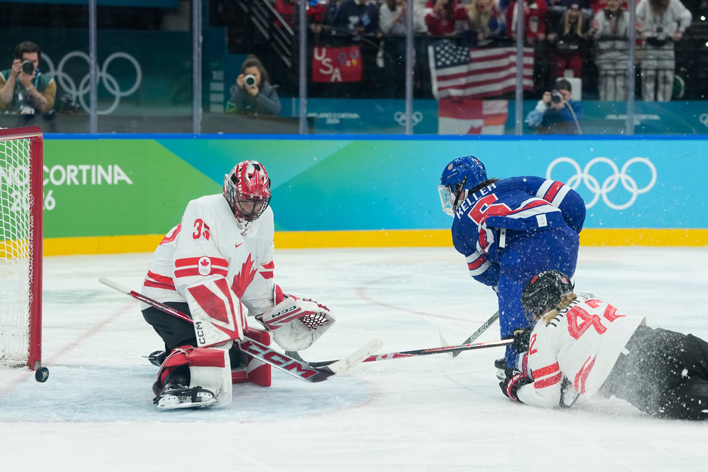 United States' Megan Keller (5) scores past Canada's Ann-Renee Desbiens (35) during a women's ice hockey gold medal game between the United States and Canada at the 2026 Winter Olympics, in Milan, Italy, Thursday, Feb. 19, 2026. (AP Photo/Petr David Josek)
