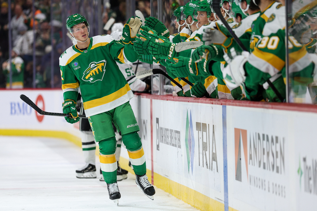 Minnesota Wild left wing Matt Boldy (12) celebrates his goal with teammates during the third period of an NHL hockey game against the Dallas Stars Thursday, Dec. 11, 2025, in St. Paul, Minn. (AP Photo/Matt Krohn)