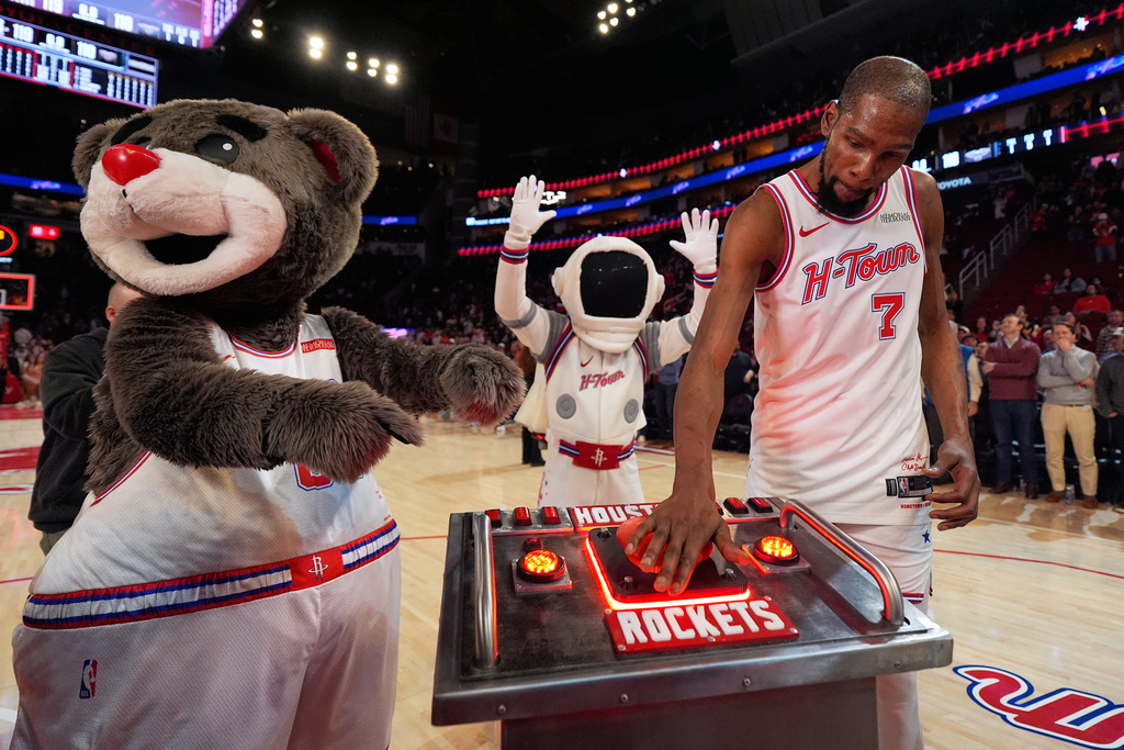 Houston Rockets forward Kevin Durant (7) presses a launch button after surpassing Dirk Nowitzki to become the NBA's sixth all-time leading scorer in an NBA basketball game against the New Orleans Pelicans in Houston, Sunday, Jan. 18, 2026. (AP Photo/Ashley Landis)
