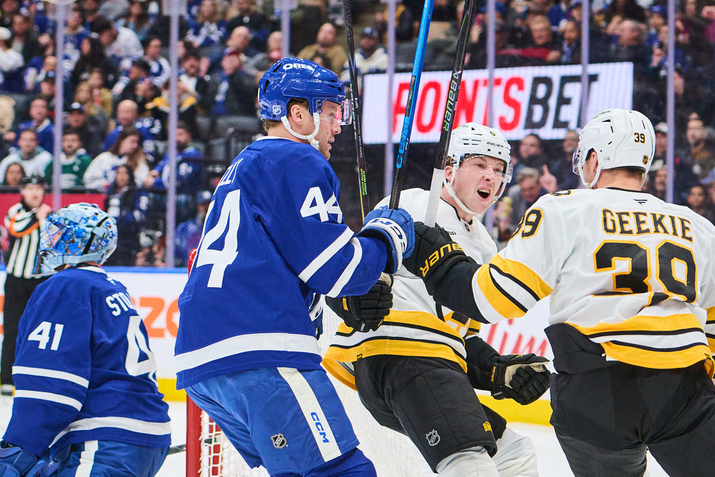 Boston Bruins' Morgan Geekie (39) celebrates his goal with teammate Mason Lohrei (6) during the first period of an NHL hockey game in Toronto on Saturday, Nov. 8, 2025. (Sammy Kogan/The Canadian Press via AP)