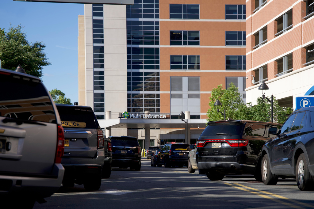 Emergency vehicles are parked outside of Wilmington Hospital in the aftermath of a shooting on Tuesday, June 16, 2026, in Wilmington, Del. (AP Photo/Mingson Lau)