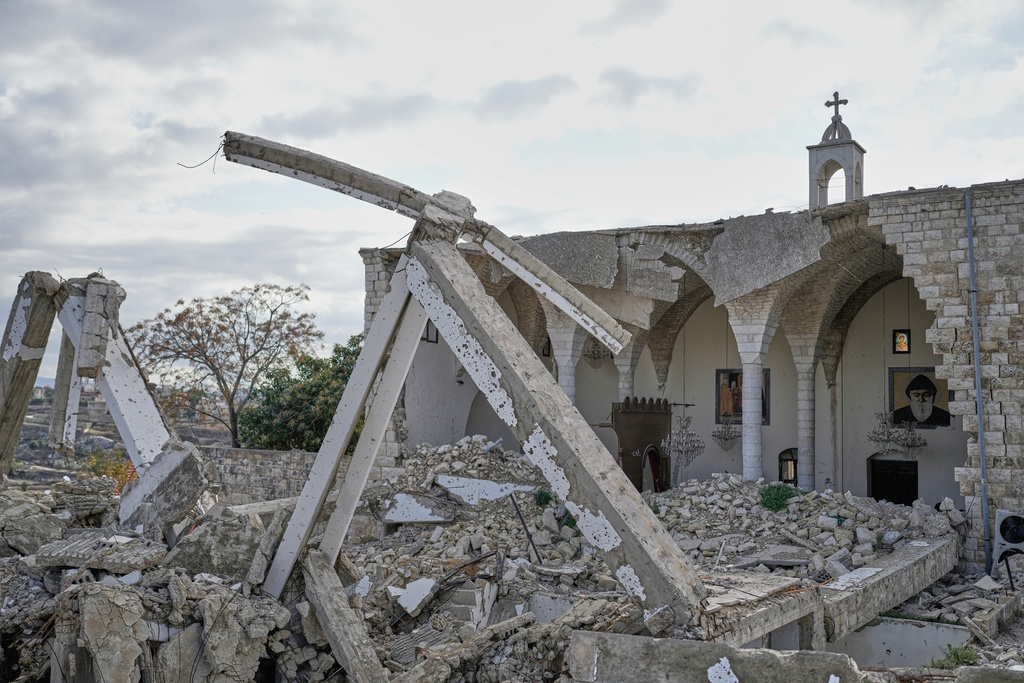 Icons hang on the remaining walls of St. George Melkite Catholic Church, which was destroyed in an Israeli airstrike, in the town of Dardghaya, southern Lebanon, Sunday, Nov. 16, 2025. (AP Photo/Hassan Ammar)
