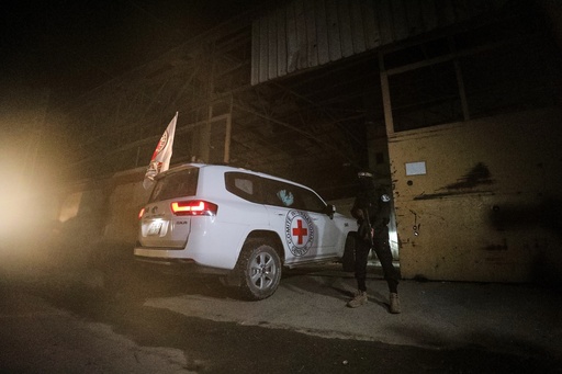 A gunman wearing the uniform of the al-Qassam Brigades, the military wing of Hamas, stands guard as Red Cross vehicles enter a warehouse allegedly to collect coffins containing the bodies of four deceased hostages, in Gaza City, Tuesday, Oct. 14, 2025. (AP Photo/Yousef Al Zanoun) A gunman wearing the uniform of the al-Qassam Brigades, the military wing of Hamas, stands guard as Red Cross vehicles enter a warehouse allegedly to collect coffins containing the bodies of four deceased hostages, in Gaza City, Tuesday, Oct. 14, 2025. (AP Photo/Yousef Al Zanoun)