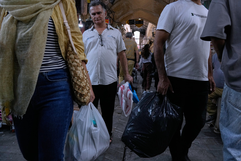 People shop at Tehran's traditional main bazaar, Iran, Saturday, Aug. 8, 2026. (AP Photo/Vahid Salemi)