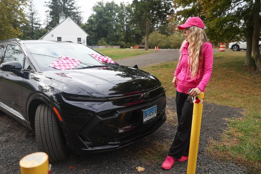 Daphne Dixon stands next to her electric vehicle near a Level 2 EV charger, Saturday, Oct. 11, 2025, in Norwalk, Conn. (AP Photo/Heather Khalifa) Daphne Dixon stands next to her electric vehicle near a Level 2 EV charger, Saturday, Oct. 11, 2025, in Norwalk, Conn. (AP Photo/Heather Khalifa)